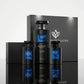 Un plan moyen de face respectant la composition exacte de image_20c739.jpg : le grand coffret cadeau noir se dresse majestueusement en arrière-plan, tandis que le flacon de gel douche de 650 ml et les deux flacons de parfum de image_20c739.jpg sont disposés avec symétrie à l'avant sur une surface lisse et noire laquée. Le sol crée un reflet miroir net et impeccable sous chaque élément. Style : Packshot commercial haut de gamme. (gemini-3.1-flash-image-preview)
