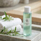 Angle 3/4 rapproché  Beauty of Joseon Green Plum Refreshing Toner displayed on smooth stone tray beside folded white towels and green botanical elements, luxury spa atmosphere, soft daylight, photorealistic skincare photography, premium Korean cosmetic advertising. (gemini-3-pro-image-preview)