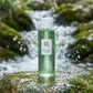 Angle légèrement en contre-plongée  Beauty of Joseon Green Plum Refreshing Toner placed on wet stone beneath a gentle waterfall, crystal clear water splashing naturally around the bottle, realistic droplets frozen in motion, premium skincare campaign, refreshing hydration concept, ultra realistic lighting, luxury cosmetic photography. (gemini-3-pro-image-preview)
