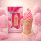 Creative e-commerce shot of the Arabiyat Sugar Cotton Blush perfume bottle and box inspired by the theme in image_b1ef0b.jpg. The items are placed on a glossy, pastel pink surface, nestled among fluffy, dreamlike clouds of real pink cotton candy on sticks. A few decorative sprinkles and a faint swirl of vanilla milk splash gracefully in the scene. The background is a soft, warm pastel pink and cream blurred bokeh gradient. Magical, fun, and sweet concept. Aspect ratio 1:1, size 1200x1200px. (gpt-image-1.5)