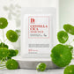 Commercial studio product photography of a Benton Centella Cica facial mask sheet pouch, perfectly centered and standing on a smooth light-gray stone pedestal. Surrounded by fresh green Centella Asiatica leaves with delicate water droplets on them. Soft, bright studio lighting, minimalist pastel green and white background, high-end skincare advertisement style, hyper-detailed, 8k resolution --ar 1:1 (gpt-image-2)